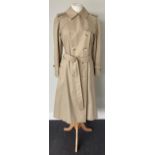 A Burberrys Lady's Stone Coloured Double Breasted Belted Trench Coat, 1980s/1990s, with slit pockets