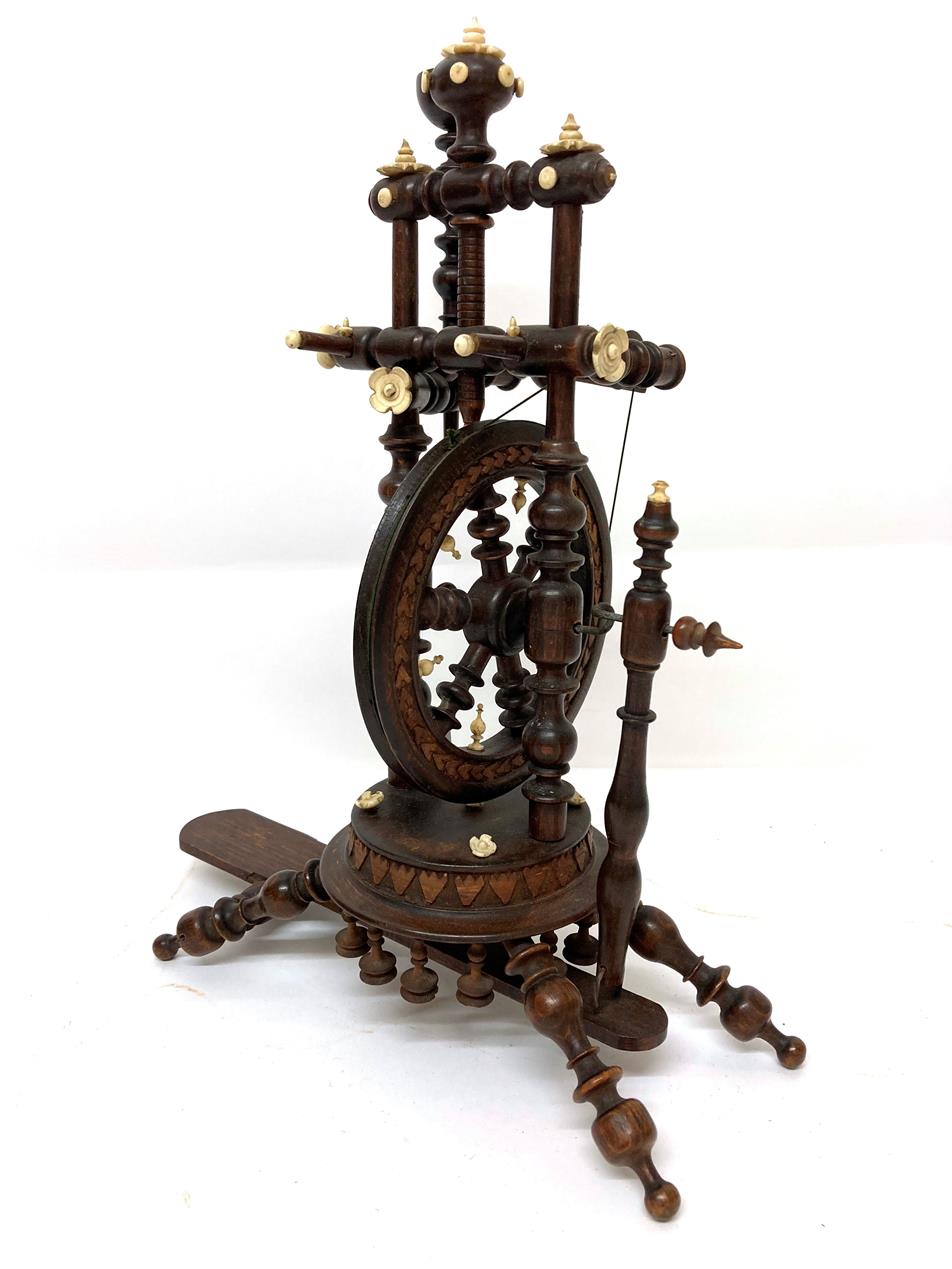 Circa 1900 Black Forest Treen Miniature Spinning Wheel, with baluster turned uprights and carved