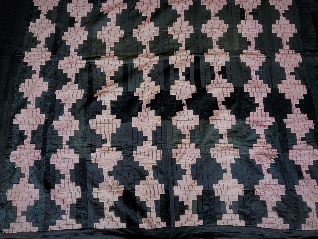 Late 19th/Early 20th Century Patchwork Quilt, incorporating pink and black patchwork motifs on a