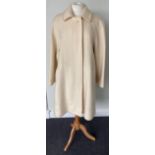 A Burberrys Lady's Cream Wool Knee-Length Coat, 1980s/1990s, with concealed button fastening and