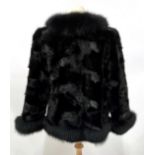 A Black Mink and Fox Fur Jacket, with bracelet length sleeves, the mink bodice trimmed with fox