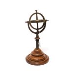 Brass Gyroscope on two axis mount on turned mahogany base disc 3 1/2'', 9cm diameter, overall height