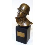 A Small Bronze Bust of a German SS Soldier, on a black marble pedestal set with a brass vacant