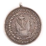 A South Devon Militia Medal of Merit 1799, the obverse with a trophy of arms enclosed by a wreath,