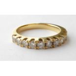 An 18 Carat Gold Diamond Half Hoop Ring, finger size O. Stamped .75ct. Gross weight 4.4 grams.