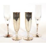 A Pair of Elizabeth II Silver Champagne-Flutes and a Pair of Elizabeth II Silver-Mounted Glass