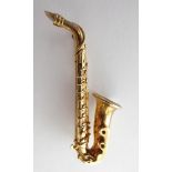 A 9 Carat Gold Brooch, in the form of a saxophone, length 4.7cm . Gross weight 10.6 grams.