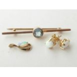 An Aquamarine Bar Brooch, unmarked, length 5.7cm; A 9 Carat Gold Opal Pendant; and A Pair of Opal