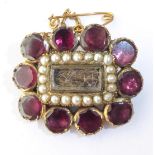 A Georgian Garnet and Seed Pearl Hairwork Mourning Brooch, measures 2.5cm by 1.5cm . Gross weight