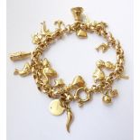 A 9 Carat Gold Charm Bracelet, hung with various charms including a bell, a plane, an elephant etc .