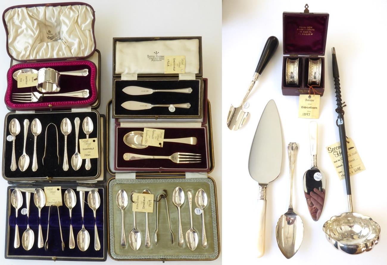 A Quantity of Silver Flatware, including: three cased sets of six silver teaspoons with sugar-