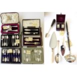 A Quantity of Silver Flatware, including: three cased sets of six silver teaspoons with sugar-