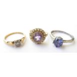 An Amethyst and Seed Pearl Ring, unmarked, finger size L1/2; A Diamond Solitaire Ring, stamped '