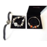 A Pandora Charm Bracelet, hung with nine charms; A Rotary Wristwatch; and An Accurist Charm Bracelet