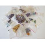 A Quantity of Loose Gemstones, including garnets, rubies, sapphires, peridot, paste, synthetic ruby,