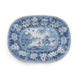 A Pearlware Meat Platter, circa 1830, printed in underglaze blue with a camel and rider, pyramids
