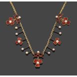 An Edwardian Enamel and Split Pearl Necklace, circa 1900, three trefoil clover clusters suspended