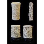 A Pair of Cantonese Ivory Sleeve Vases, late 19th century, carved and pierced with dragons amongst