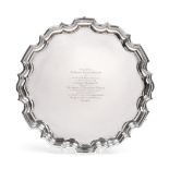 A George V Silver Salver, by Carrington and Co, London, 1922, shaped circular and on three pad feet,