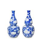 A Pair of Chinese Porcelain Double Gourd Vases, late 19th century, painted in underglaze blue with