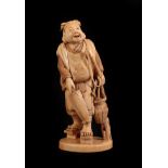 A Japanese Ivory Okimono as a Fisherman, Meiji period, standing holding a rod, basket and