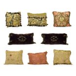 A Collection of Eleven Cushions, early 20th century, and some parts earlier, variously worked with