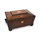 A Regency Rosewood Work Box, circa 1820, of rectangular form with ring handles and gadrooned angles,