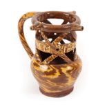 A Halifax Slipware Puzzle Jug, dated 1889, of traditional form with three spouts and pierced neck,