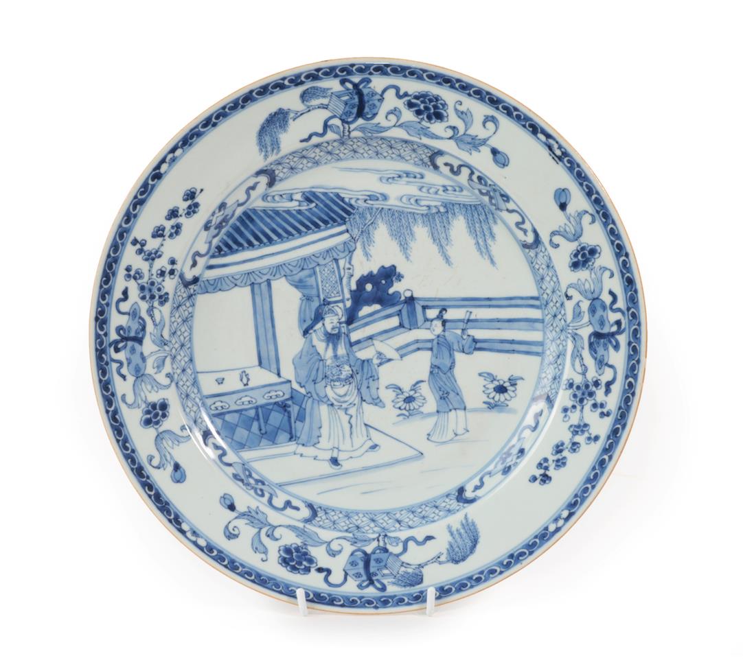 A Chinese Porcelain Dish, Kangxi, painted in underglaze blue with figures in a fenced garden