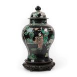 A Chinese Porcelain Baluster Jar and Cover, 19th century, painted in famille noire enamels with