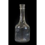 A Glass Serving Bottle, circa 1740, the cylindrical neck with trailed string ring over an
