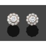 A Pair of Diamond Cluster Earrings, a raised central round brilliant cut diamond within a border