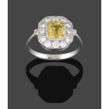 An Art Deco Style Yellow Sapphire and Diamond Ring, the central emerald-cut yellow sapphire within a