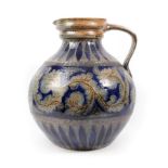 A Rhenish Saltglazed Stoneware Large Jug, possibly 1903, of ovoid form with strap handle, incised