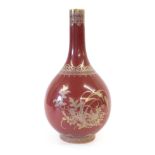 A Chinese Porcelain Bottle Vase, Qianlong reign mark but not of the period, gilt with stylised