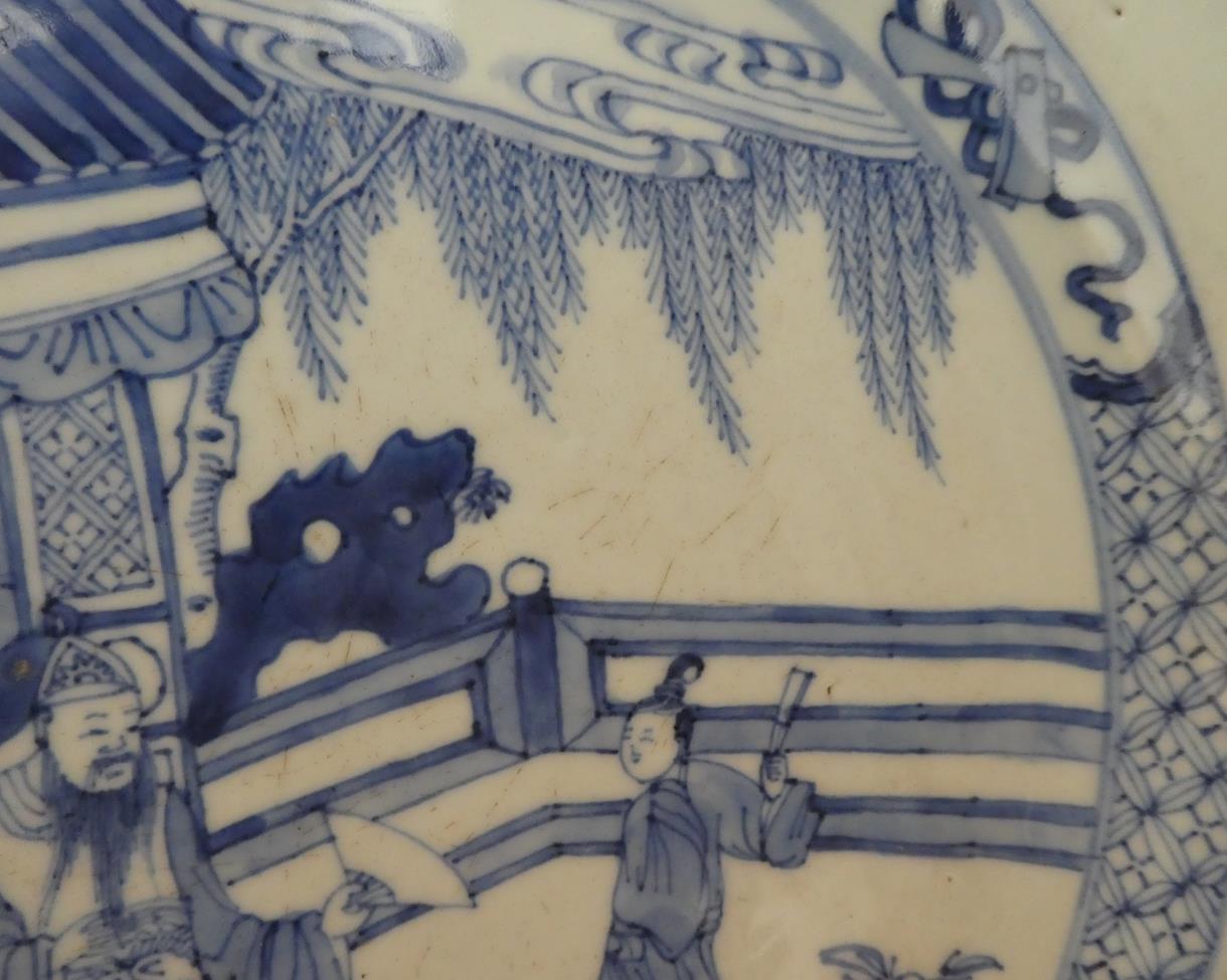 A Chinese Porcelain Dish, Kangxi, painted in underglaze blue with figures in a fenced garden - Image 3 of 3