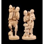 A Japanese Ivory Okimono as a Father, Meiji period, holding a bird in one hand, a child in the
