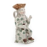A Staffordshire Pottery Squire Toby Jug, 19th century, the seated figure with brown hat and green