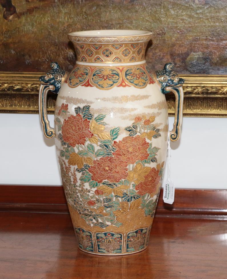 A Satsuma Earthenware Vase, Meiji period, of baluster form with flared neck and twin mask handles,