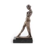 Pierre Le Faguays (1892-1962): Meditation, A French Art Deco Silvered Spelter Bookend, modelled as a