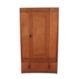 An Arts & Crafts Oak Wardrobe, with ebony stringing, the single door above a drawer, 107.5cm wide,