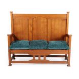 An Arts & Crafts Oak Hall Bench/Settle, with capped uprights and feet, panelled back and slatted