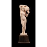 An Art Nouveau Carved Ivory Figure, circa 1910, of a nude maiden carrying a water urn, on a bovine