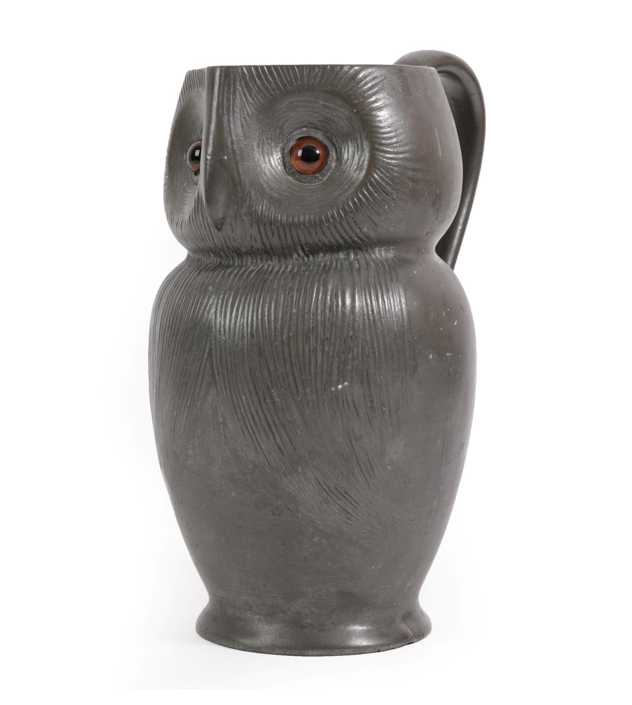 A Liberty & Co, London English Pewter Owl Jug, circa 1902, cast in the form of an owl with glass