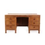 Robert Mouseman Thompson (1876-1955): An English Oak Panelled Kneehole Desk, 1930's, with upstand,