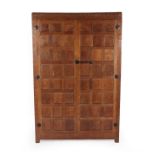 Robert Mouseman Thompson (1876-1955): An English Oak Panelled Double Wardrobe, 1930's, with half