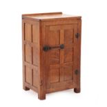 Robert Mouseman Thompson (1876-1955): An English Oak Panelled Bedside Cupboard, 1930's, with