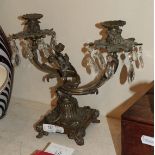 A patinated bronze twin light candelabra