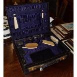 A George V silver-mounted travelling dressing-table service, London, 1919 and 1920, the silver