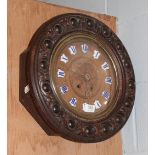 An oak wall clock with blue enamel chapters